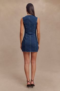 Denim devotion. The JANE Button Down Denim Mini Dress is a stylish and versatile addition to any wardrobe. Featuring a round neckline and a centre front button closure, this sleeveless dress offers a clean and classic look. The front mock pockets and princess seams add subtle detailing, enhancing the dress's tailored fit. With its mini length, the Jane dress is perfect for both casual outings and dressier occasions, combining the timeless appeal of denim with modern design. Jane Dress, Princess Seams, Denim Mini Dress, Princess Seam, Denim Mini, Classic Looks, Round Neckline, Latest Fashion Trends, Button Downs