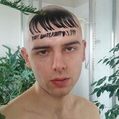 a young man with his hair cut into the shape of letters on his forehead and undercuts