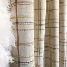 the back of a plaid curtain with white feathers