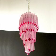 a pink chandelier hanging from a ceiling