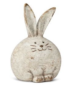 a white rabbit statue sitting on top of a table