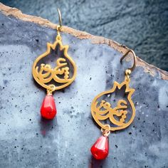 According to the mythology of ancient Greece, the pomegranate was seen as a symbol of life and rebirth. This symbolism is brought to life in these stunning earrings, made of 18k gold plated stainless steel and adorned with Persian  calligraphy that spells out the word "love." Each pair is unique and one of a kind, making them a special addition to any jewelry collection. Not only are these earrings beautiful, but they are also hypoallergenic and anti-tarnish, ensuring they will remain in pristin Red Brass Jewelry For Anniversary, Red Garnet Earrings Gift, Red Garnet Earrings For Gifts, Symbolic Red Jewelry As Gift, Gold Garnet Earrings As Gift, Yellow Gold Garnet Earrings For Gift, Red Spiritual Jewelry, Traditional Garnet Jewelry Gift, Traditional Garnet Jewelry For Gifts