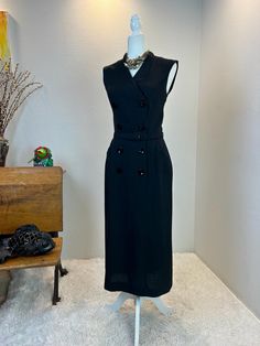 1950s Dress / 1950s Linen dress / 50s dress / vintage black linen dress / 1950s Tabak dress / vintage wiggle dress / vintage travel dress  I absolutely adore this 1950s / 1960s Tabak linen dress. It was made by Tabak of California who was well known for making women's sports wear in the 1950s and 1960s. This beauty has the classic 1950s pencil cut with the 1960s mid style. I love her huge buttons, mandarin collar, and dramatic hip pockets that really give you that hourglass shape.  This beauty maybe in a deep black linen, but it has so much west coast summer style.  She is the perfect travel dress as she is made of a thick linen. Hand wash and hang dry and she is ready to go. A true classic beauty to add to your wardrobe. Measurements provided are flat and have been doubled. Bust 34" Waist Black Chic Dresses For Vintage Style, Chic Black Vintage Fashion Dress, Vintage Midi Dress With Buttons For Formal Occasions, Vintage Black Midi Dress For Spring, Black Vintage Midi Dress For Spring, 1950s Style Black Vintage Dress For Spring, 1950s Black Vintage Dress For Spring, 1950s Black Vintage Dress, Black 1950s Vintage Dress For Spring