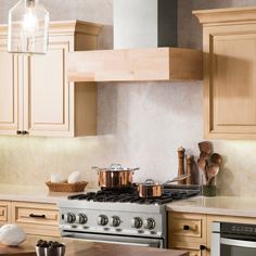 a stove top oven sitting inside of a kitchen next to wooden cabinets and counter tops