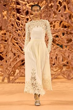 Featured in Look 39 of our Autumn/Winter 2024 runway show, the Palermo Dress is crafted from our Victorian-inspired cotton-silk fabrication that’s adorned with blossoming lines of Battenberg lace, creating a decorative floral pattern along the neckline, sleeves, and hem. This pearly white beauty has elegant long sleeves and flows to an elongated midi hem. It fastens with a concealed side zipper and buttons at the back neckline. Composition: 70% Cotton, 30% Silk Pair with our Mini Floret Stud to Spring Evening Midi Dress With Lace Work, Spring Evening Midi Dress With Lace, Spring Silk Dress With Lace Patchwork, Elegant Embroidered Midi Dress, Spring Evening Dress With Cutwork Hem, Silk Long Sleeve Dress With Lace Trim, Spring Lace Dress With Intricate Embroidery, Battenberg Lace, Nyc Boutiques