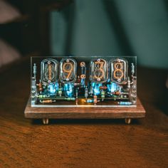 an electronic clock sitting on top of a wooden table