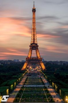 the eiffel tower lit up at night with lights on it's sides