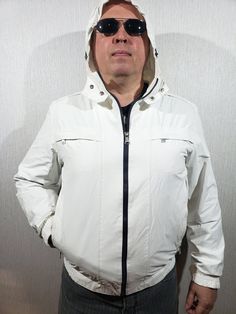 Reliable men's bomber jacket with a zipper. White raincoat and comfortable men's hooded jacket. The jacket is easily fastened with a plastic zipper. In the front, the jacket has two convenient pockets at the bottom, and two at the top with a zipper. Inside the jacket there is one pocket with a zipper. A great option for the jacket is the hood, which closes with a drawstring and metal snaps. The sleeves of the jacket are fastened with metal snaps. A pleasant lining covers the upper part of the jacket. The jacket is pleasant and comfortable to wear and will perfectly emphasize your sporty look, and will also be perfect for you on the road, at work and on vacation. MEASUREMENTS Jacket length                 67  cm  |  26.5 in Pit to pit                          60 cm  |  23.5 in Chest circumf Urban White Windbreaker With Detachable Hood, White Urban Windbreaker With Detachable Hood, White Urban Hooded Jacket With Detachable Hood, Casual White Weatherproof Windbreaker, Casual White Weatherproof Outerwear, White Weatherproof Winter Raincoat, White Winter Outerwear For Rainy Weather, Casual White Waterproof Hooded Jacket, Winter Weatherproof White Raincoat