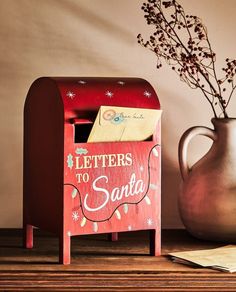 a red mailbox with letters to santa written on it