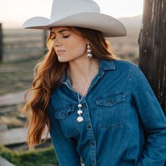 Add a touch of classic elegance to your outfit with The Kimberly Going Out Pendant. Featuring 3 hand-engraved conchos, this bold and beautiful sterling silver pendant will be a timeless addition to your jewelry collection. Elevate your style with this must-have piece! This necklace measures 3" long, with the conchos measuring 3/4" wide, 7/8" wide, and 1" wide. Includes an adjustable chain. Pair with similar items from the The Kimberly Collection! All Vogt sterling items come with the Vogt Family Western Rodeo Outfits, Rodeo Outfit, Colorado Style, Tooled Leather Belts, Rodeo Outfits, Cowboy Up, Western Belt Buckles, Silver Belt Buckle, Country Women