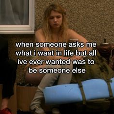 a woman sitting on the floor with a suitcase in front of her and an image of someone asking me what i want in life