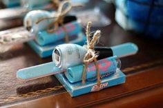 two small figurines sitting on top of a wooden table next to each other