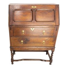 an old wooden dresser with brass handles