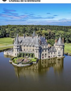 an aerial view of a castle in the middle of a lake