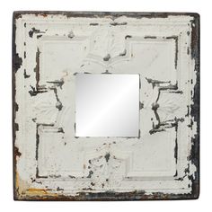 an old metal frame with a square mirror on the front and bottom, painted white