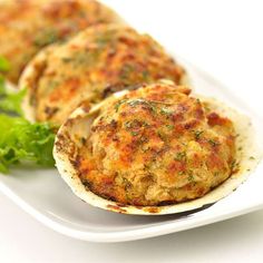 three crab cakes on a white plate with lettuce