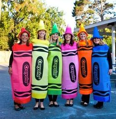 group of people dressed in colorful crayons costumes standing next to each other outside