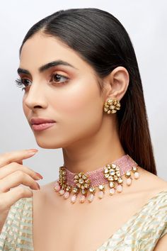 Gold toned choker with pink stones embellished, teardrop detail and equal-spaced floral kundan motifs. Comes with a pair of floral earrings.
Components: 1 Choker, 1 Pair of Earrings
Type: Stone, Kundan, Polki, Beads
Composition: Copper
Color: Gold,Pink
Kundan work
Stone embellished
Stud earrings - Aza Fashions Polki Choker Set, Jewellery Set Gold, Polki Choker, Choker Jewellery, Kundan Work, Pink Stones, Stone Choker, Choker Set, Jewelry Choker