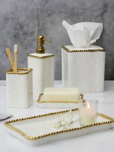 bathroom accessories including soap dispenser, toothbrush holder and tissue