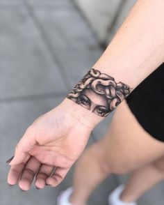 a woman's hand with a tattoo on it