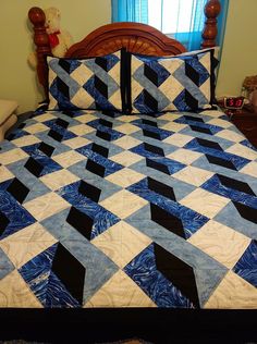 a blue and white quilt on a bed