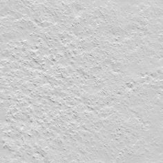 a white wall that has been painted with some type of paint and is very rough