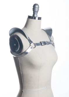 This chestpiece shoulder harness adds drama and impact to any outfit. Epaulette shoulder "wing" details. Show them you mean business! This piece works especially well with dresses and flowing tops that don't have a defined waistline. Silver toned nickel-plated steel hardware. Shown in silver metallic leather (silver leather is now lined and stitched!). Also available in black leather, black vegan leather, and PVC.Buckles in front across chest. All pieces are MADE TO ORDER, standard sizes XS-4XL. Gothic Fitted Harness With Adjustable Straps, Fitted Belt Harness For Cosplay, Fitted Harness With Belt For Cosplay, Epaulettes Fashion, Leather Epaulettes, Wing Harness, Leather Harness Women, Silver Bodysuit, Fashion Illustration Portfolio