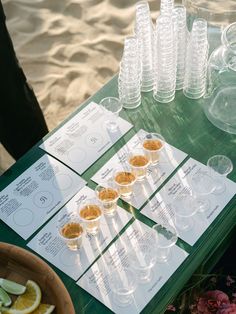 a table topped with lots of cups filled with food