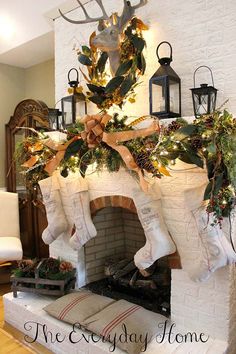 a fireplace decorated for christmas with stockings and greenery