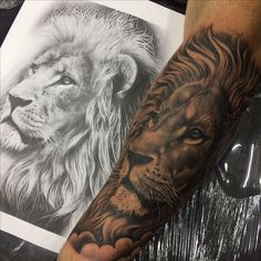 a man with a lion tattoo on his arm next to a drawing of a lion