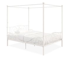 a white metal bed frame with four posts