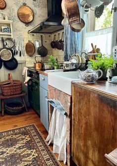 a kitchen filled with lots of pots and pans on top of a stove top oven