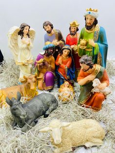 a group of figurines sitting on top of hay