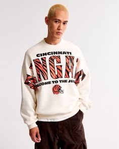 NFL Cincinnati Bengals Graphic Crew Sweatshirt | NFL NFL | Abercrombie.com Male Features, Colorful Sweatshirt, Classic Sweatshirt, Men's Tops, Cincinnati Bengals, Carolina Panthers, Die Hard, Philadelphia Eagles, Crew Sweatshirts