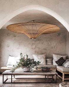 a living room filled with lots of furniture and pillows on top of a wooden table