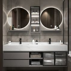 a bathroom with two sinks and three mirrors