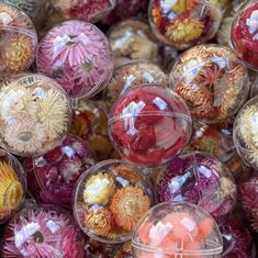 many different colored glass balls are stacked up in the same pattern and size as well