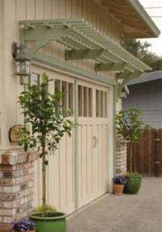 several potted plants in front of a house