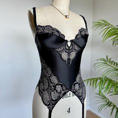 Vintage Christian Dior Lingerie Bustier Corset Top//Sultry black stretch satin and lace inset panels. Pearl wreath at the bust, garter straps and hook and eye closure at back. Amazing condition! Size 36B. Price firm Length: 18.5" top of strap to bottom of body  Waist: 24-28" stretchy  We ship internationally! Pearl Wreath, Vintage Christian Dior, Corset Lingerie, Lace Inset, Stretch Satin, Bustiers, Corsets, Black Stretch, Corset Top