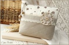 a purse sitting on top of a table next to a basket and lace doily