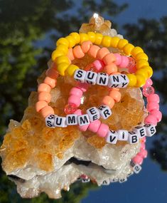 "SUNNY SUMMER VIBES- Beaded Bracelet Trio  Bracelets are made on .8mm elastic stretch cord, pony beads, square alphabet beads, and secured knotting.   BRACELET 1- \"SUNNY\" in square alphabet beads with yellow Pony beads BRACELET 2- \"SUMMER\" in square alphabet beads with orange Pony beads BRACELET 3- \"VIBES\" in square alphabet beads with pink Pony beads. Perfect for anyone and occasion.  Spice up your personalized vibe with these stylish, personal, unique bracelets.  This is the perfect accessory to dress up your summer wardrobe." Summer Playful Beaded Bracelets With Letter Beads, Playful Summer Beaded Bracelets With Letter Beads, Orange Stretch Bracelet With Letter Beads For Beach, Trendy Summer Beaded Bracelets With Letter Beads, White Letter Beads Stretch Bracelet For Summer, White Stretch Bracelet With Letter Beads For Summer, Playful Beaded Bracelets With Letter Beads For Vacation, Yellow Letter Beads Bracelets For Summer, Summer Stretch Bracelet With Letter Beads As Gift