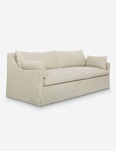 a white couch sitting on top of a white floor