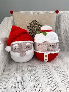 two knitted santa and mrs claus pillows