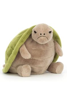 a stuffed turtle with a green blanket on its head and eyes, sitting in front of a white background