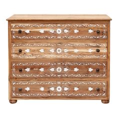 an old wooden chest with white paint on the top and bottom drawers, decorated with floral designs