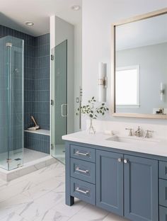 a bathroom with blue cabinets and white counter tops