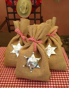 two burlock bags sitting on top of a red and white checkered table cloth