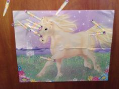 the unicorn is holding two toothbrushes in it's mouth