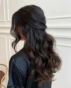 the back of a woman's head with long dark hair