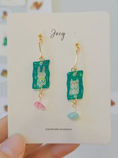 About Joey Joey is an original handcrafted jewelry brand known for its playful and cute designs. The designer expertly uses materials like polymer clay, shrink plastic, resin, and clay to create whimsical pieces. From shrink plastic bird earrings to polymer clay animal-shaped studs and resin apple rings, each piece is full of charm and creativity. 🐼More Joey's Products👈 Product Detail Material: Plastic, UV, Resin, 18k Gold Plated Brass(Needle)Tech: HandmadeStyle: Cute/Chill/CasualOccasion: Daily/Weekend Casual/Going Out/Travel/ShoppingProduct Note: 1. All pictures are taken in real-life scenarios, and color variations may exist under different lighting conditions. 2. This product is expected to take 5-8 days to produce, please understand!3. This is a model picture of the piece you will r Playful Handmade Polymer Clay Jewelry, Playful Hand Painted Resin Jewelry, Handmade Playful Resin Jewelry, Handmade Polymer Clay Earrings For Birthday, Playful Hand Painted Dangle Jewelry, Cute Everyday Green Jewelry, Cute Dangle Resin Jewelry, Playful Polymer Clay Dangle Jewelry, Cute Resin Dangle Jewelry